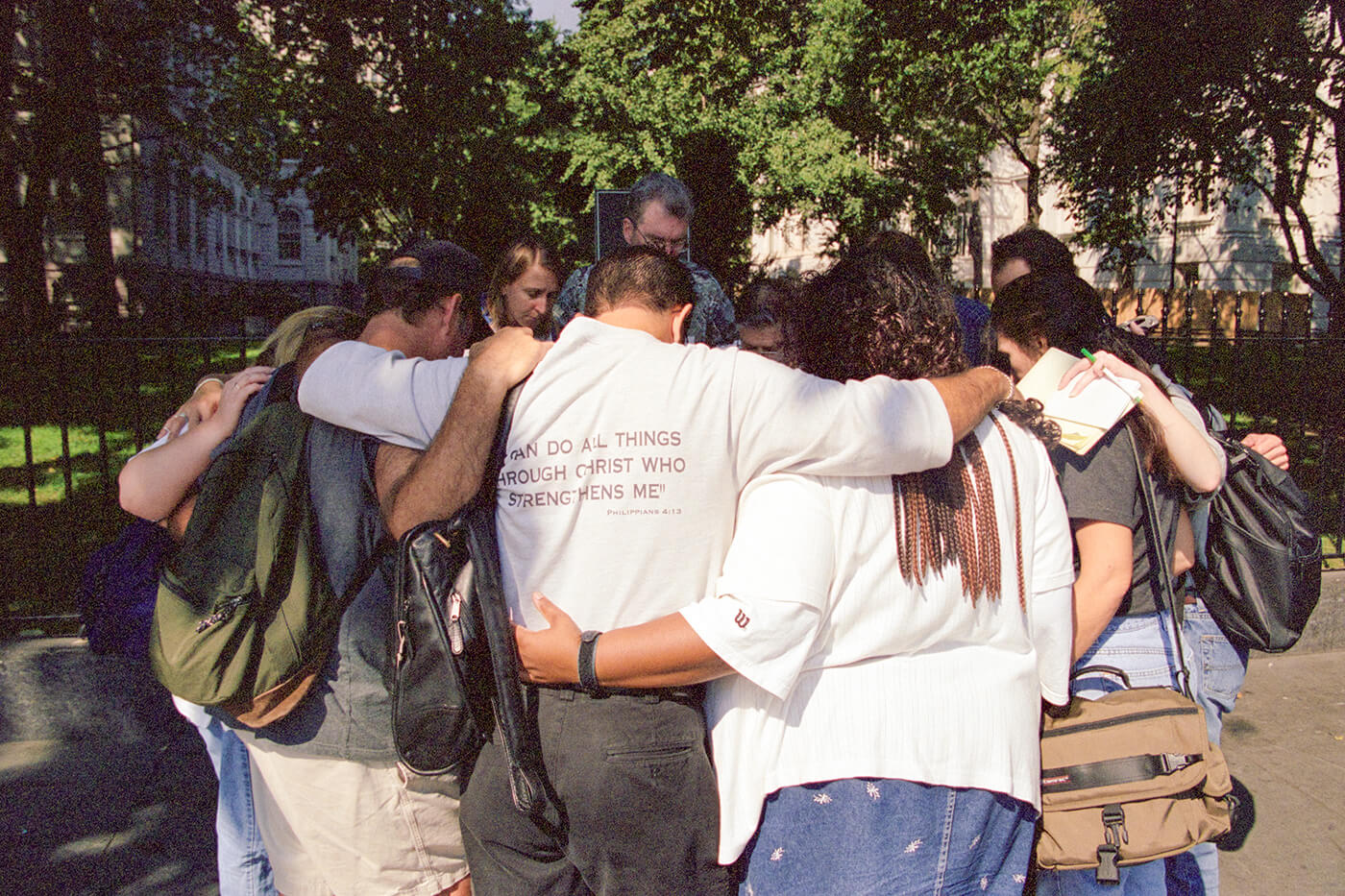 A group of people praying in a circle