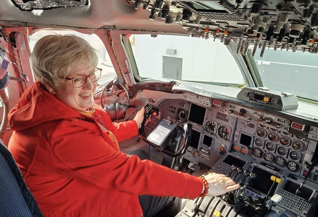 Marina sitting in the cockpit of a plane