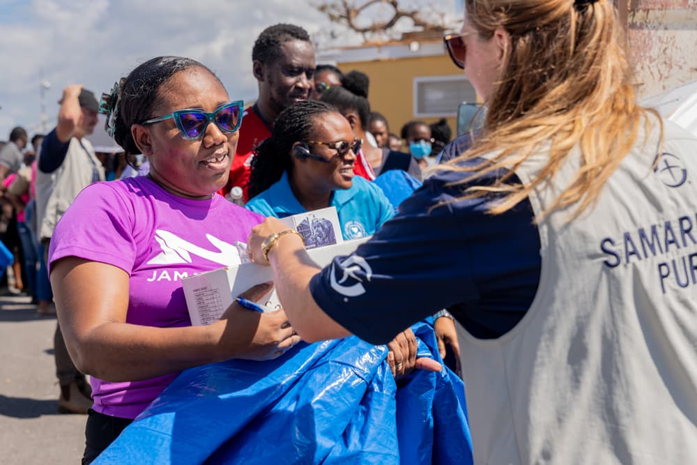 A Samaritan’s Purse team member distributes shelter materials to families.