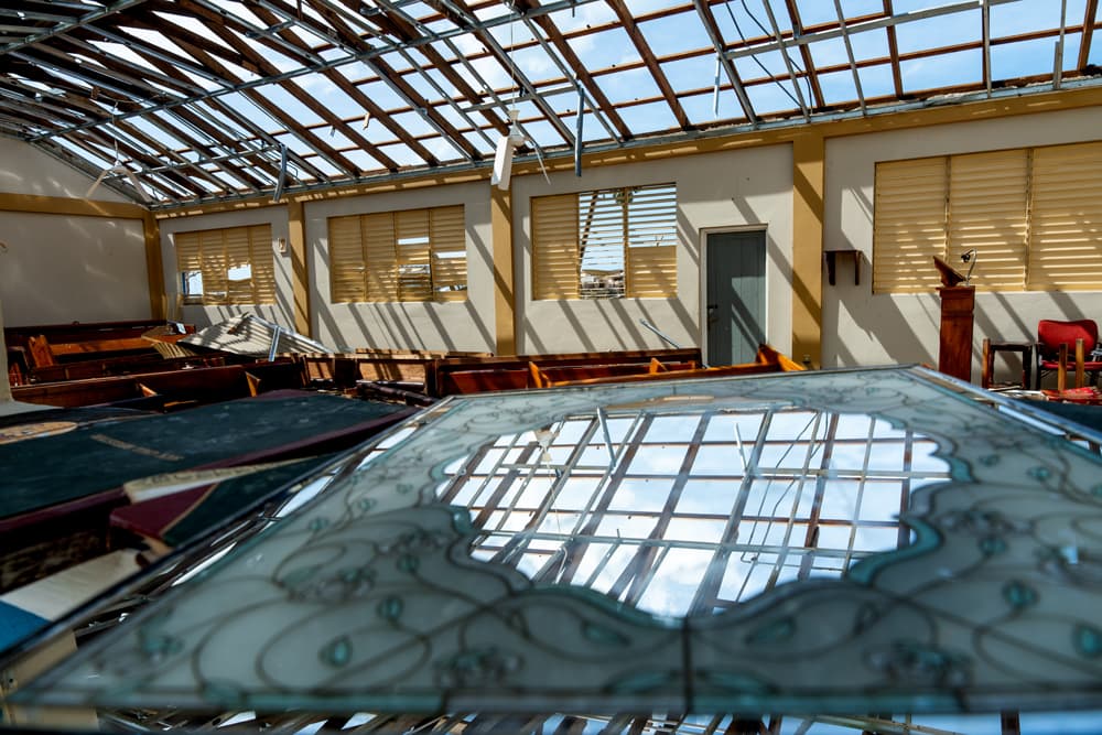 Interior of a church with its roof torn off and debris scattered inside after Hurricane Melissa in Jamaica.
