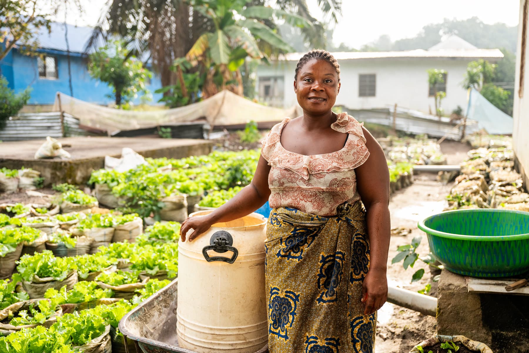 Tutu, an Eden project beneficiary, stands in her garden.