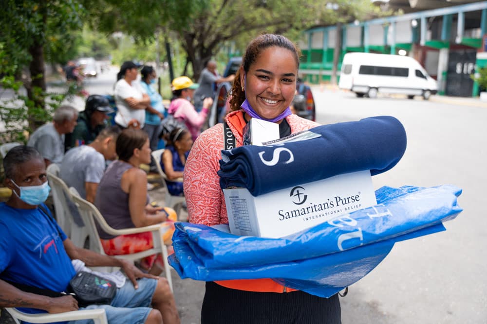 Venezuelan woman receiving supplies