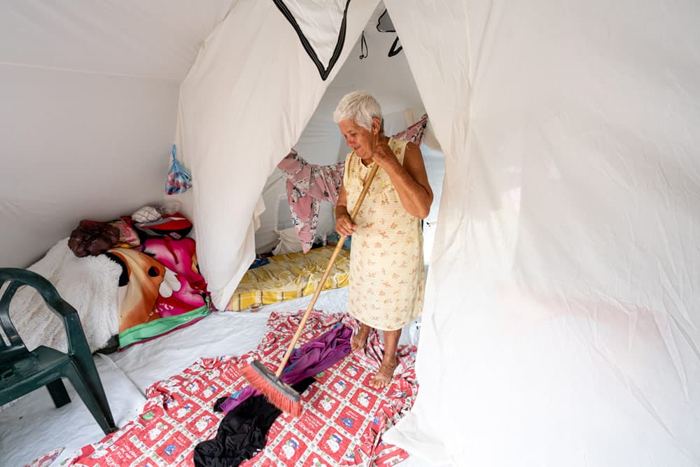 A local woman tidies up inside the tent provided to her and her family by Samaritan's Purse.