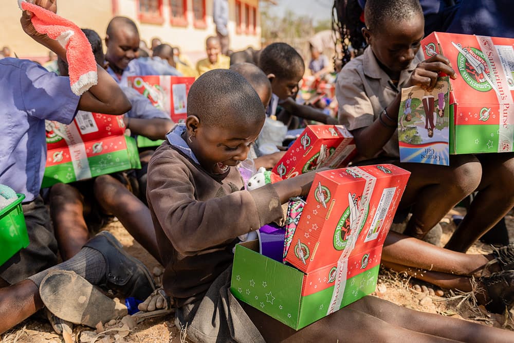 A Himba child opens their gift