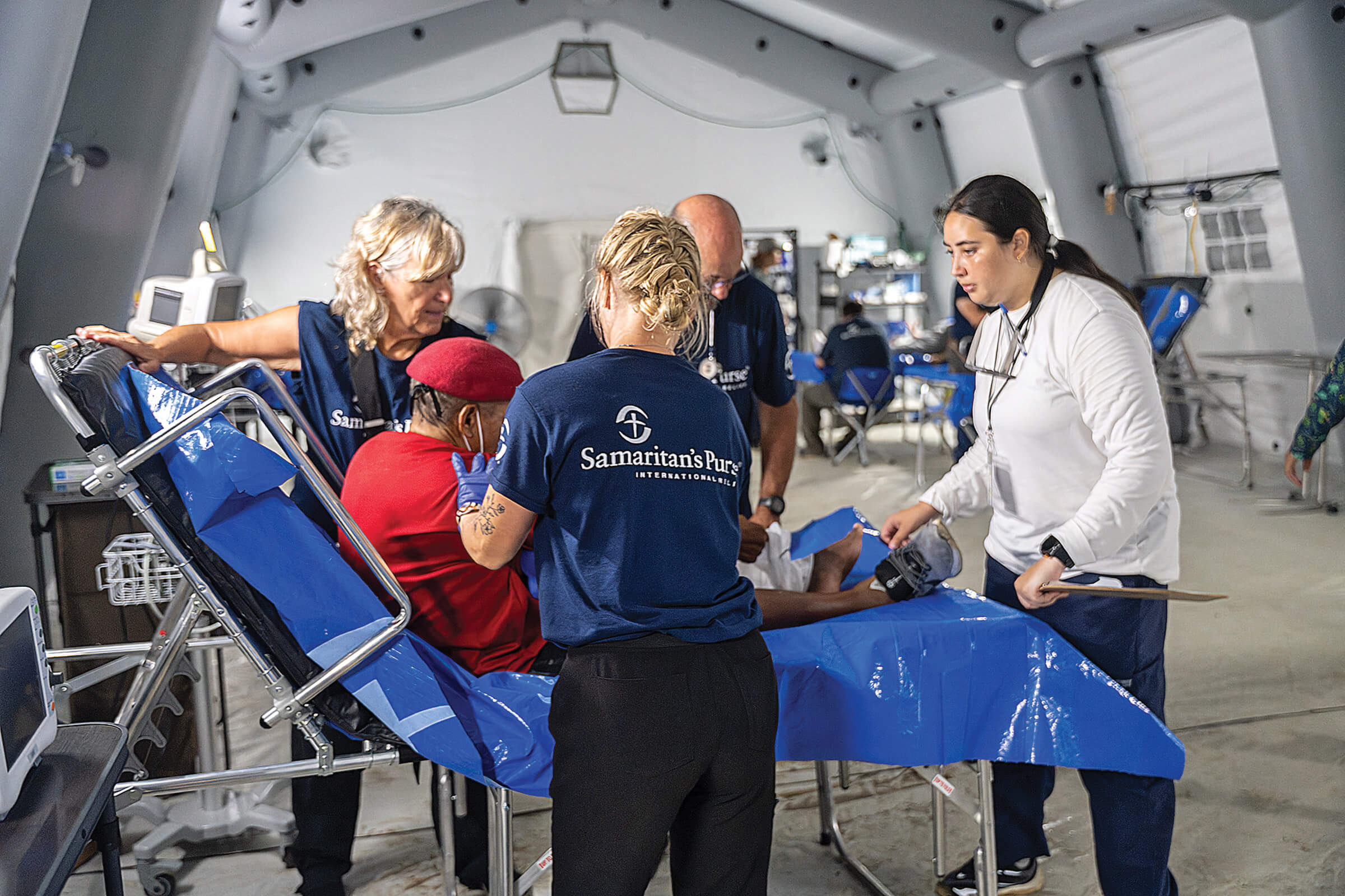 a patient being helped in our Emergency Field Hospital