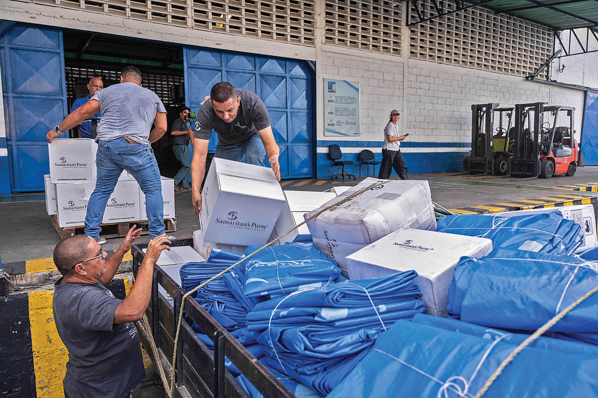 our teams distribute tarps, water, solar lights, blankets, and other items