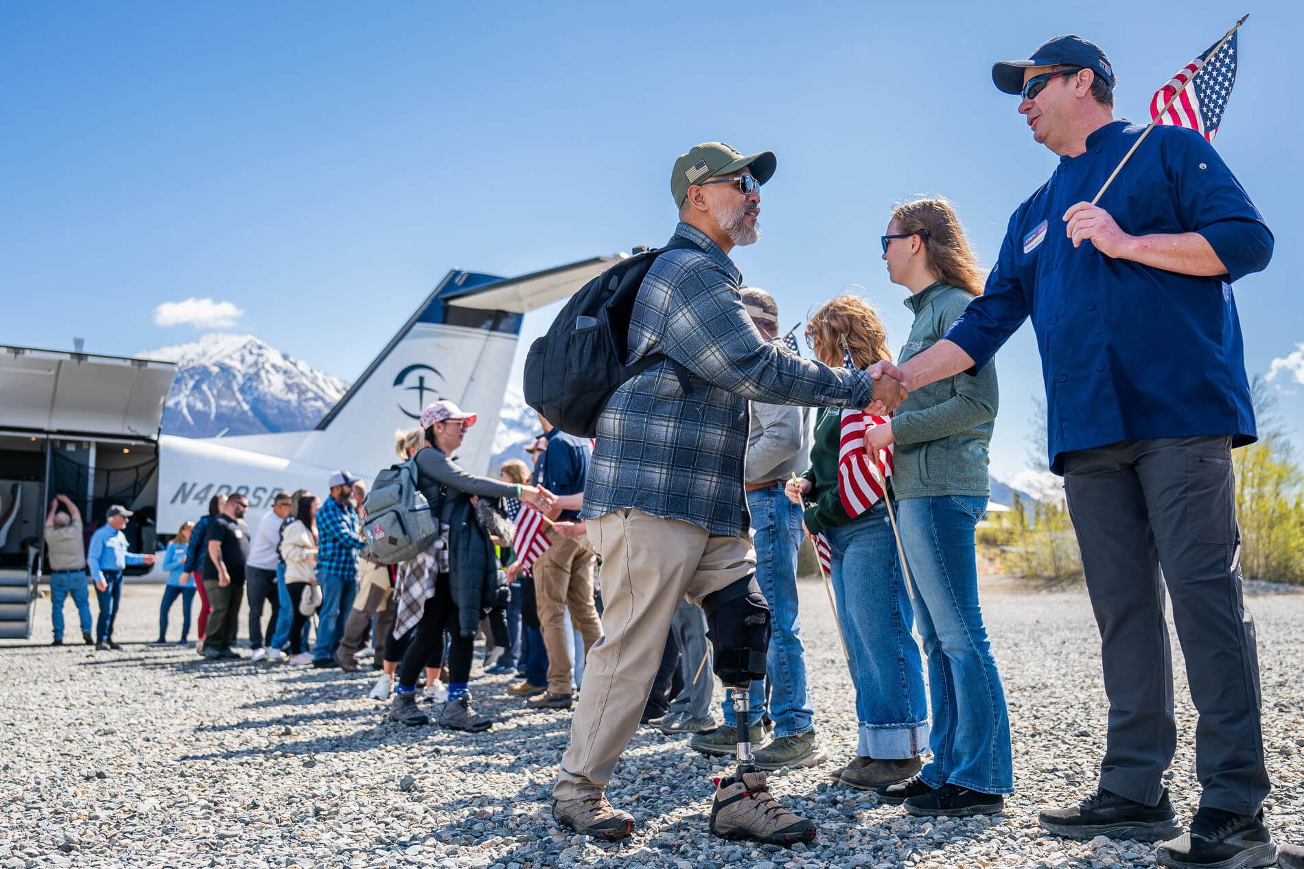 A man is greeted after arriving in Alaska