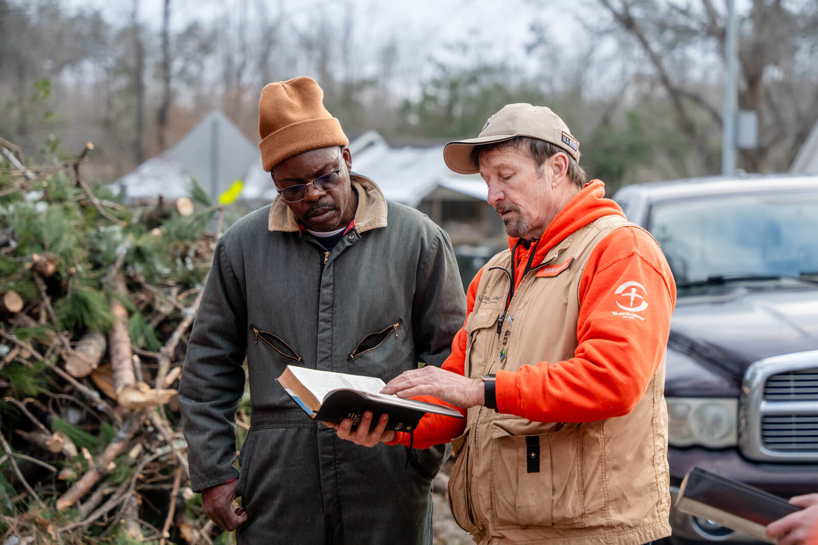 a Samaritan's Purse volunteer presents a bible to homeowner Michael Fox in Oxford, Mississippi