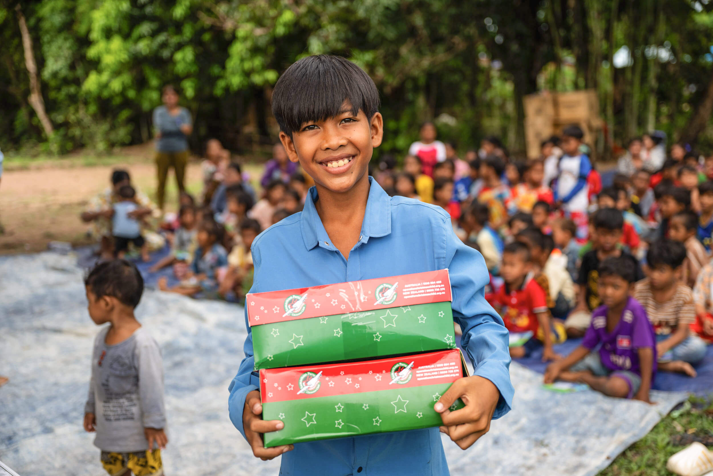 Samay holding his Operation Christmas Child shoebox in Cambodia