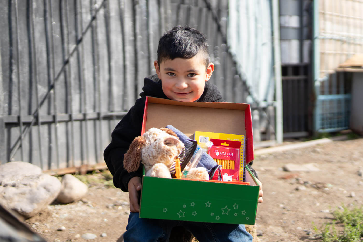 smiling boy with his shoebox gifts in Chile