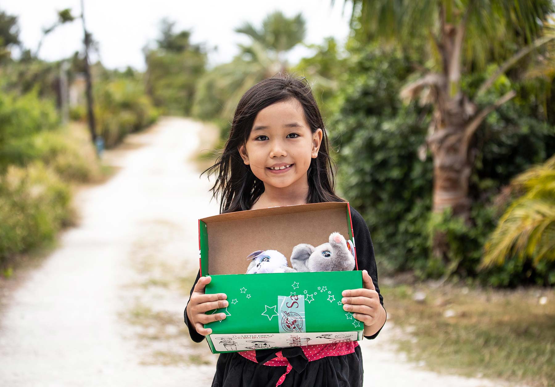 a girl in Saipan with her gifts