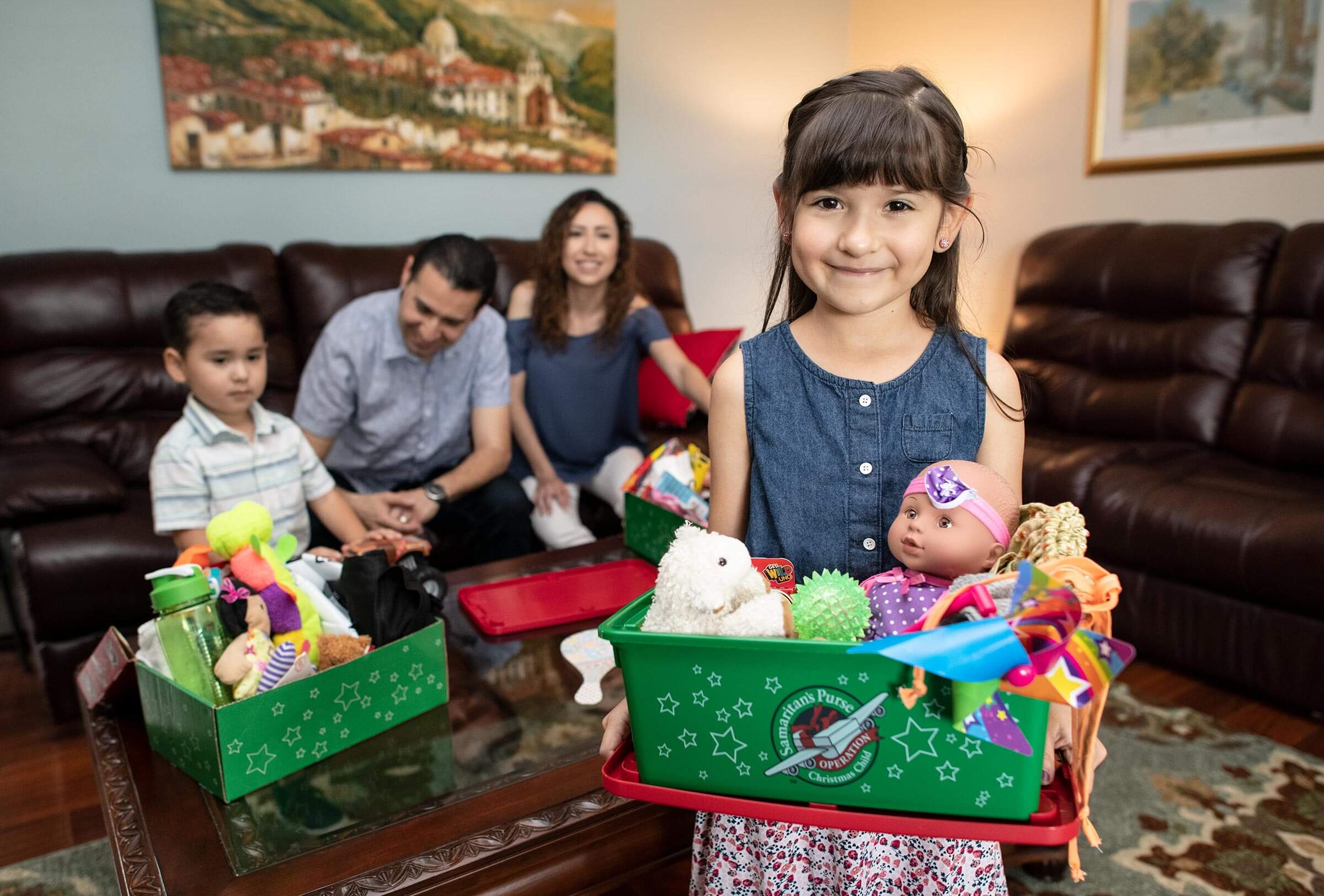 a family packing shoeboxes