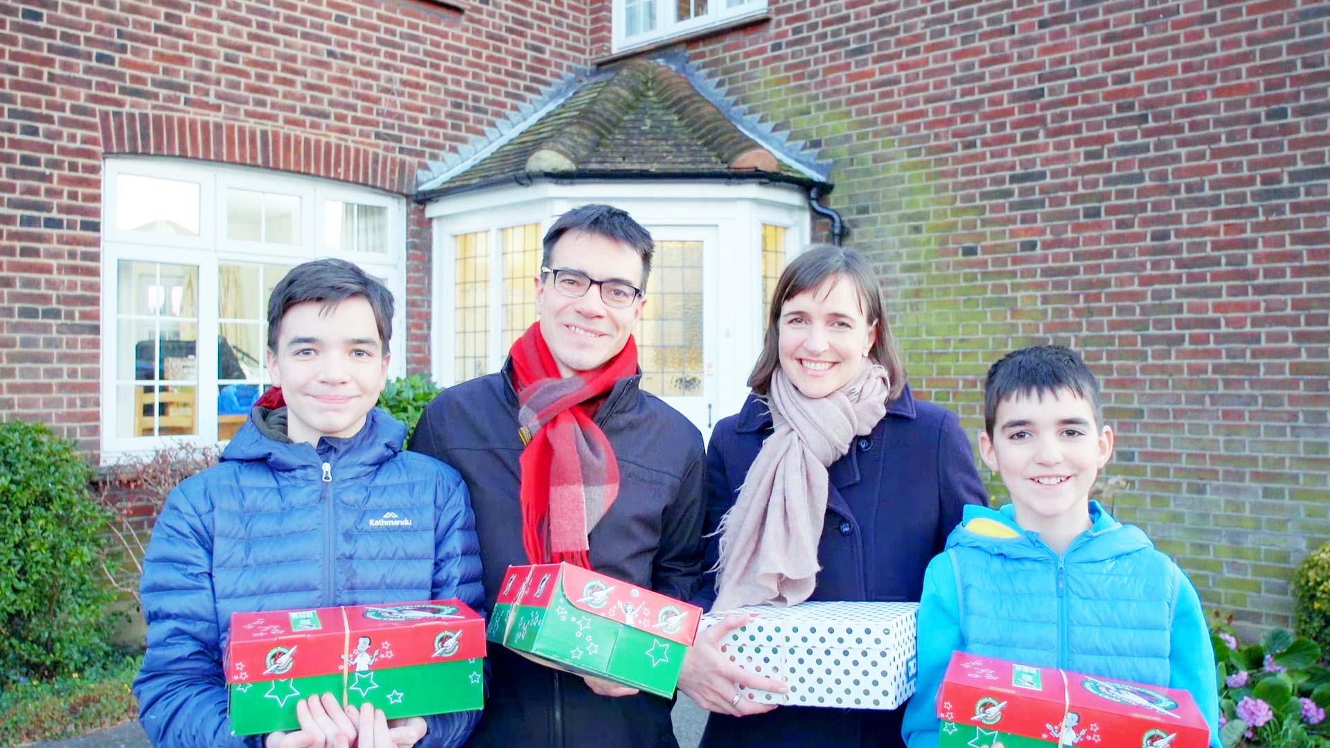 a family packing shoeboxes