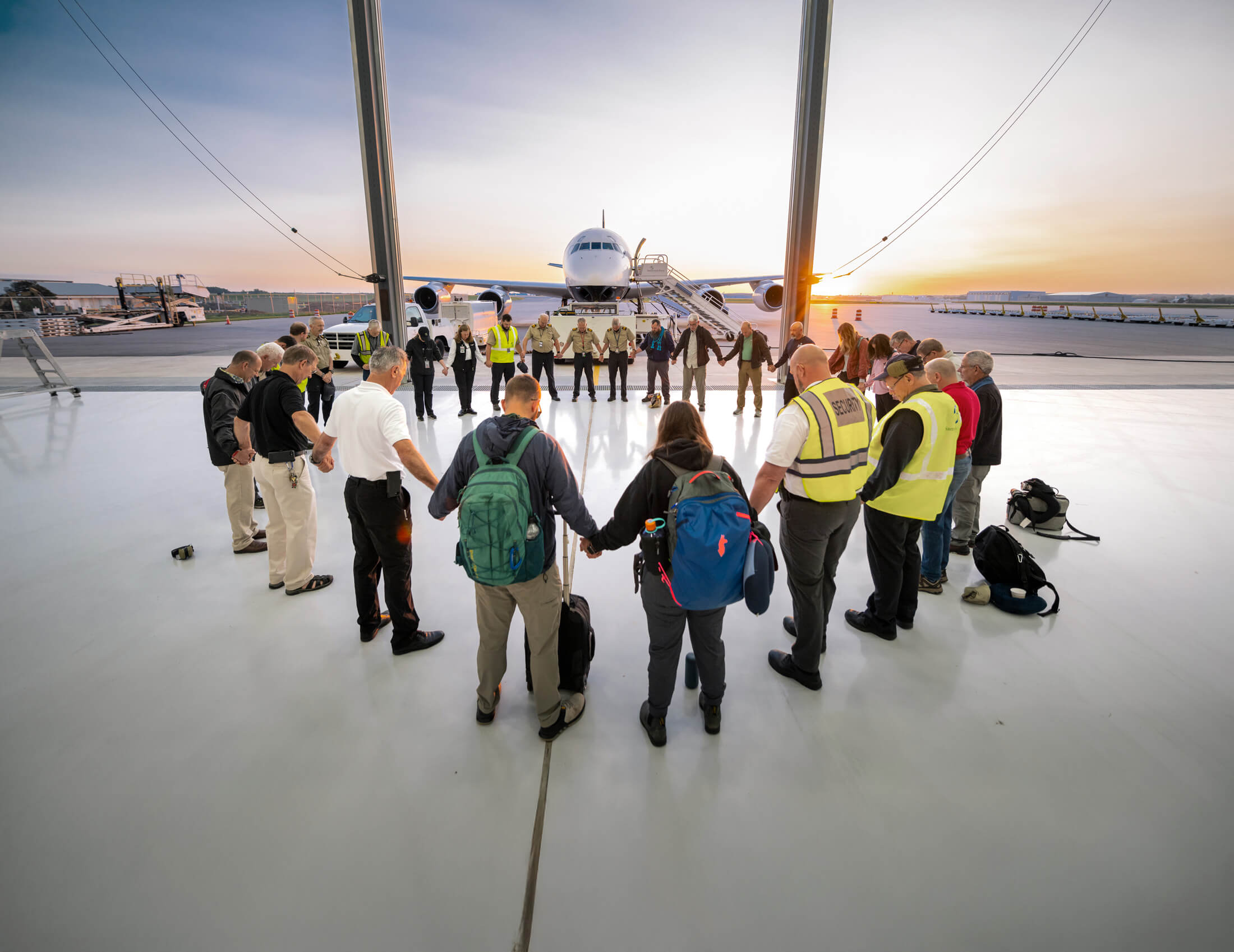 A group of Samaritan's Purse volunteers gather in a circle to pray