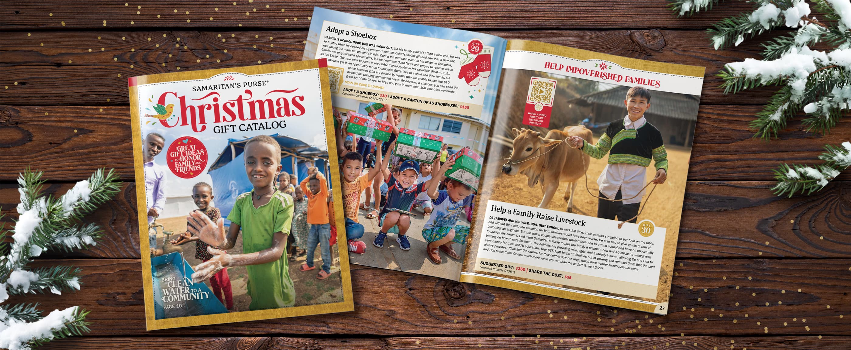 Example of printed copy of the 2025 Christmas Gift Catalog laying on a wooden table with snow tipped evergreen branches laying to the left and right side